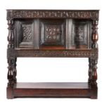 A small Charles I oak standing small livery cupboard, circa 1630, the later rectangular top with a