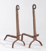A pair of 18th century andirons, the scrolled terminals above leafy-vein decorated uprights, on