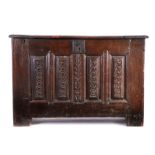 A 16th century oak chest, Northern French, the rectangular hinged top above a deep top rail and