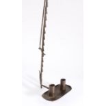 An 18th century wrought iron adjustable travelling candle holder, with hinged and ratchet arm, and