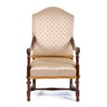 An early 18th century walnut and upholstered armchair, the arched stuff over back and seat