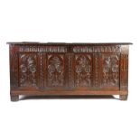 A Charles I oak coffer, circa 1630, with quadruple panel to the front with nullled-carved top rail