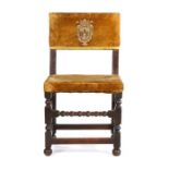 A Cromwellian oak and upholstered side chair, circa 1640, the upholstered back centred by a