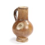 A 17th century stoneware jug, Cologne/Frechen, the spout above a loop hand and bulbous body with