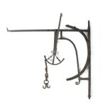 An 18th century iron chimney crane, the corner bracket with an arched adjusting arm, the crane with