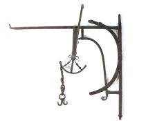 An 18th century iron chimney crane, the corner bracket with an arched adjusting arm, the crane with