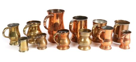 A group of twelve 19th century brass and copper measures, English and Scottish Of baluster,