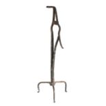A 19th century iron table rushlight holder, the angled jaws above a sprung arm and tripod base,