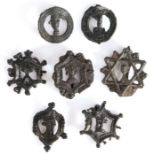 Seven 14th century pewter pilgrim/secular badges, each with the bust of man within a decorative