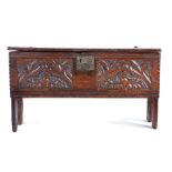 A unusual 16th century boarded and carved oak coffer, English, the rectangular top with channel