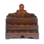 A George III elm and oak cawl spoon rack, the shaped backplate with hanging aperture, above three