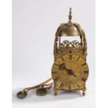 An 18th century brass lantern clock, the bell held under the cross frame above pierced dolphin