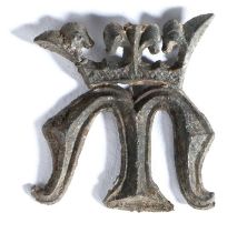 A 14th/15th century pewter pilgrim's badge, designed with a letter 'M' below a crown, 32mm high