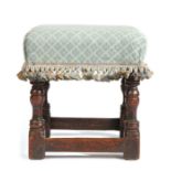 A Charles II oak and upholstered stool, circa 1660, the square stuff-over seat upholstered in duck-