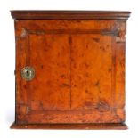 An early 18th century oak and walnut-veneered spice cabinet, circa 1700-20, the rectangular top