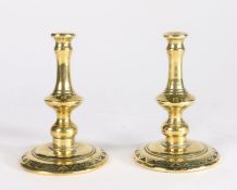 A pair of Victorian brass tapersticks, circa 1880 Each with baluster-shaped stem, peened over into a