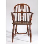 A mid-19th century yew, ash and elm Windsor armchair, North East Midlands, the hooped back above a