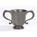 A George II twin-handled pewter ‘loving’-cup, circa 1750, the flared body with mid-fillet and