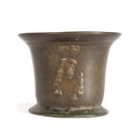 A Charles II leaded bronze mortar, circa 1670, the body with flared lip cast twice with a bust of