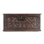 A boarded oak box, West Country, circa 1600-20, the front board carved with adorned scrolling