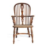 A mid-19th century elm Windsor armchair, the hooped back with pierced splat and spindles, the