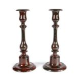 A pair of late19th century Cornish serpentine candlesticks Each of red and dark green mottled