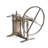 An 18th century weight driven brass spit jack, the scroll brass frame with turned pillars and drum,