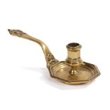 An unusual 18th century small cast brass chamberstick, French, circa 1730-40, having an octagonal-