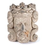 A carved stone head of a king, probably 14th century, English or French, wearing a crown, with well