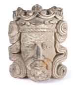 A carved stone head of a king, probably 14th century, English or French, wearing a crown, with well
