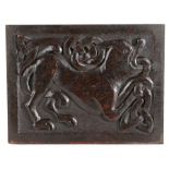 An 18th century oak carved panel, the rectangular panel designed with a mythical beast issuing from