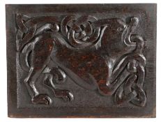 An 18th century oak carved panel, the rectangular panel designed with a mythical beast issuing from
