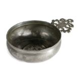A pewter porringer, English, circa 1700 The single ear with triangular bracket, bellied bowl with