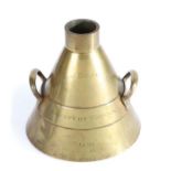 A Victorian brass alloy Imperial Standard measure, the conical body with lug handles and marked '