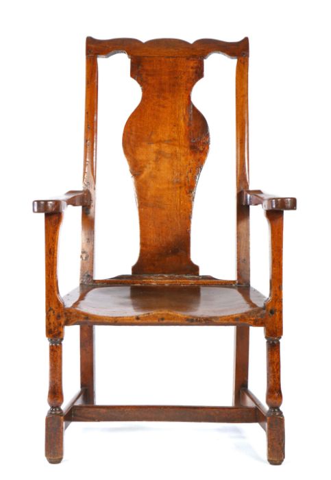 A highly unusual George II walnut armchair, probably Welsh, circa 1750, with serpentine top rail,