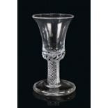 An 18th Century firing glass, circa 1750, the bell bowl above a spiral air twist stem and wide foot,
