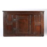 A Charles I joined oak food cupboard, West Country, circa 1640 The central door flanked by pairs of