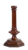 A treen candlestick of late 17th century design, with fluted pillar, octagonal collar and beaded