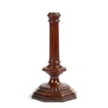 A treen candlestick of late 17th century design, with fluted pillar, octagonal collar and beaded