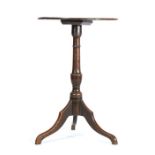A George III oak wine table, having a good one-piece circular top, on a vase-turned pillar and