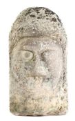 A carved stone head, in the Anglo-Saxon manner, with worn facial features, large eyes and broad