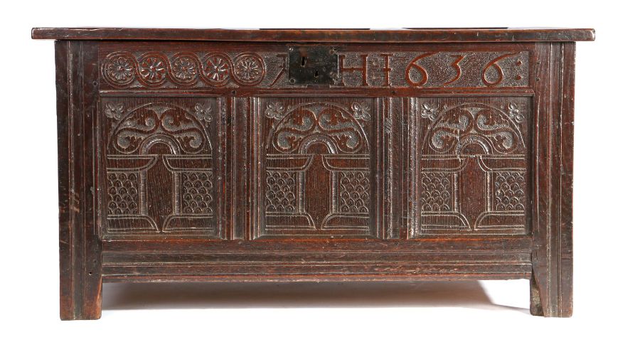 A Charles I oak coffer, dated 1636, with triple-panelled lid, the front of three panels, each