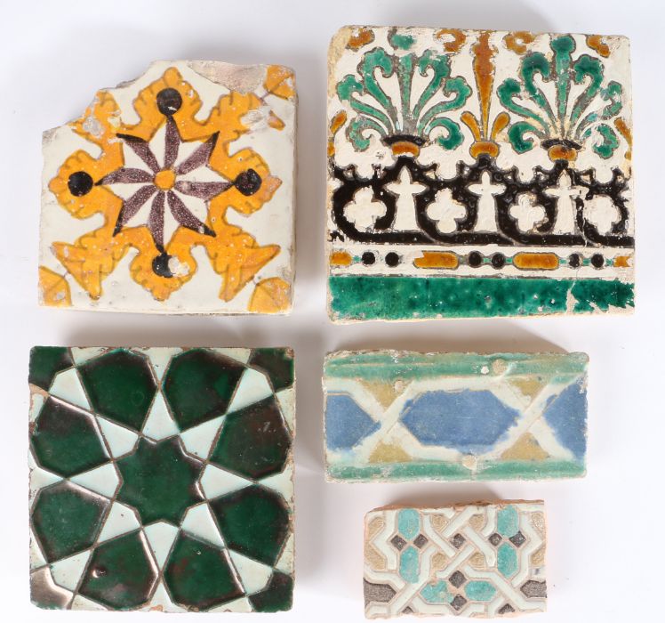 A 17th century tile, Spanish, Moorish star design in dark green lustre, together with a black and