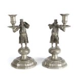 A pair of early 19th century pewter figural candlesticks, German In the manner of a