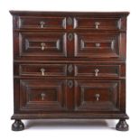 A Charles II oak chest of drawers, circa 1680, the rectangular top above four long mitre-moulded