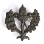 A 15th century pewter secular badge, designed as an acorn flanked by oak leaves, 32mm high This