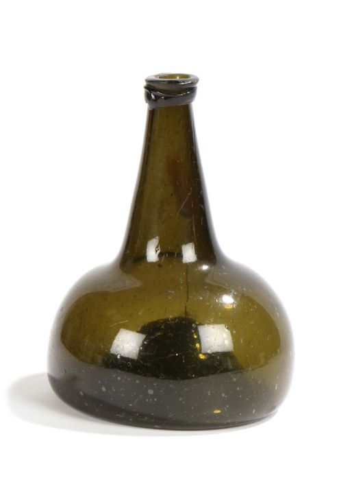 An early 18th century green glass 'onion' bottle, the lip above a conical shaped neck and bulbous