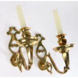 A pair of cast brass wall sconces 18th century and later, each with a shaped and pierced backplate
