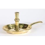 An early 18th century brass ejector candlestick, circa 1700-20 The stem centred by a shallow ball-