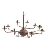 A wrought iron chandelier, the simple tapering shaft with suspension hook, terminating in a large